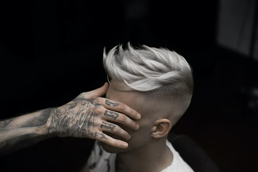 tattooed guy with his platinum hair color